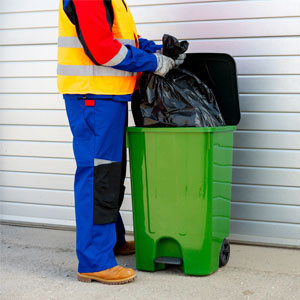 ROMO Junk Removal - garbage collector collecting garbage from the trash bin.